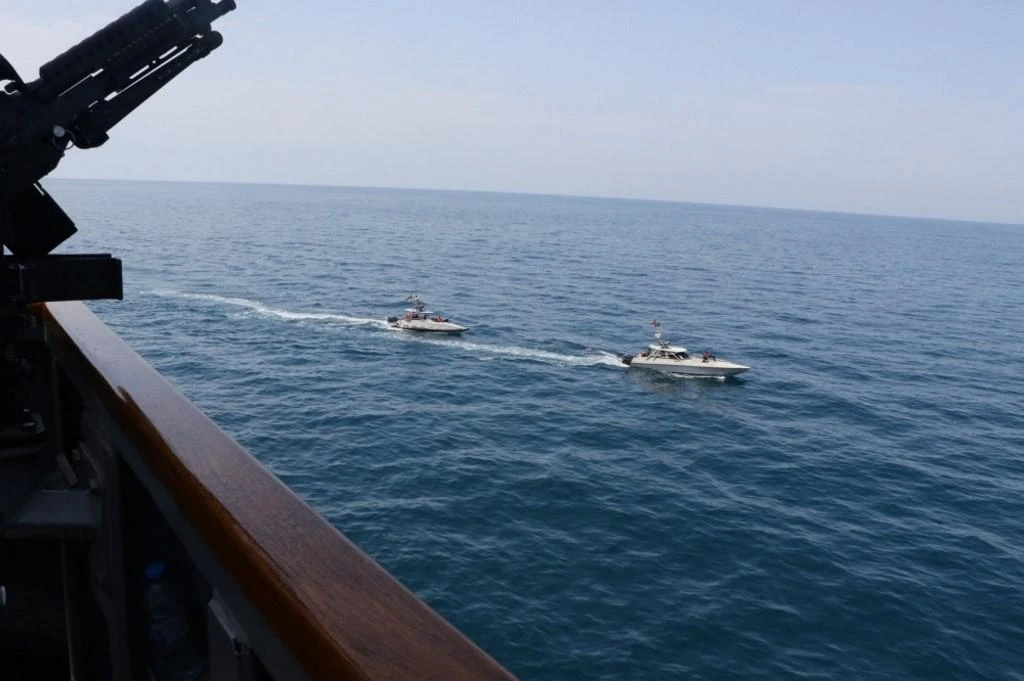 Iranian Islamic Revolutionary Guard Corps Navy loiter near the guided-missile destroyer USS Paul Hamilton and other US military ships on 22, 2020. (Navy Office of Information/AFP)