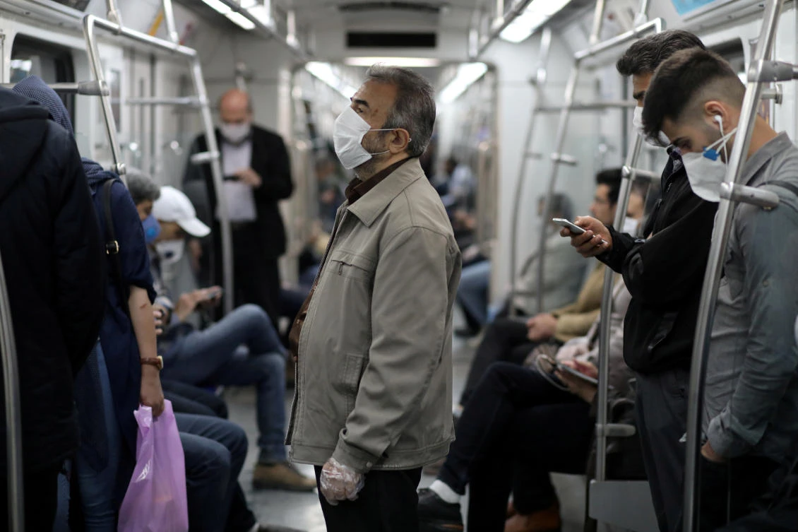 Iranians wear protective face masks against the risk of coronavirus contagion as they ride in the metro, in Tehran, Iran, May 20, 2020. (Reuters)