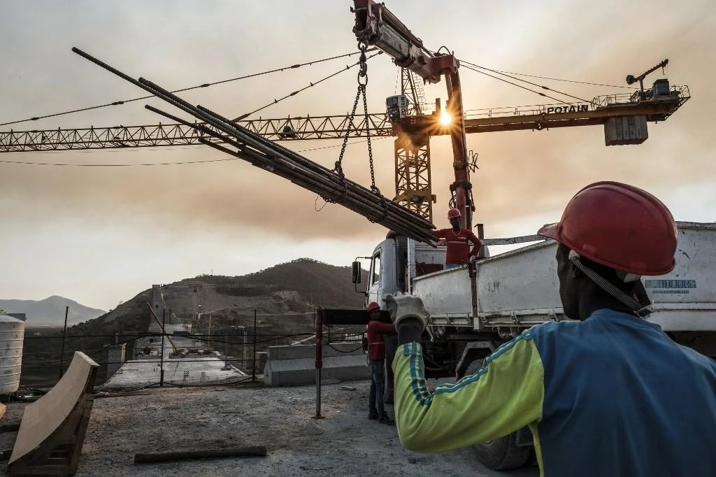 Ethiopia said it would not delay filling the Grand Ethiopian Renaissance Dam, above, which it began constructing in 2011. Workers move iron bars with a crane at the unfinished reservoir on December 26, 2019. (AFP)