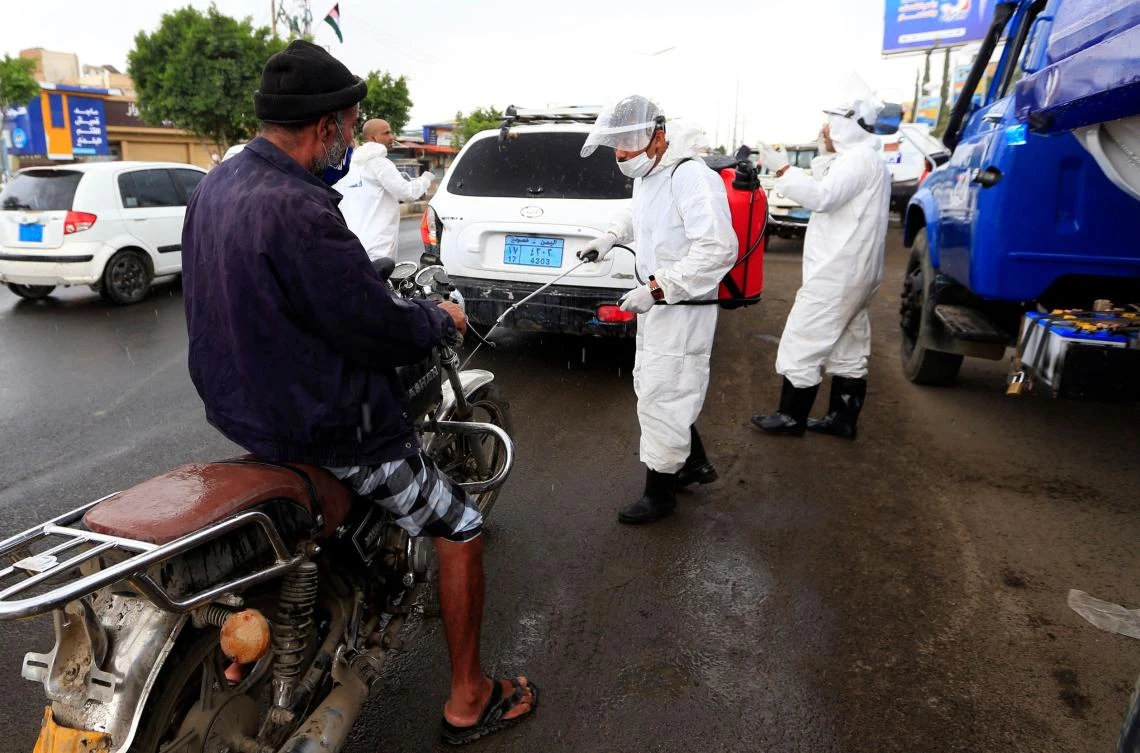 Yemen authorities have reported 184 cases including 30 deaths. Above, a health worker sprays disinfectant on a motorcycle in Sanaa on May 21, 2020. (AFP)