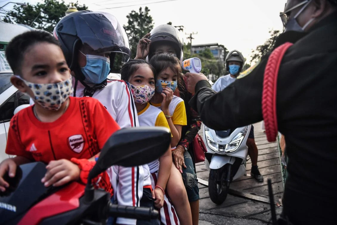 Thailand has eased earlier lockdown restrictions amid concerns over the spread of coronavirus. Above, a family have their temperatures taken before entering a public park in Bangkok on May 22, 2020. (AFP)