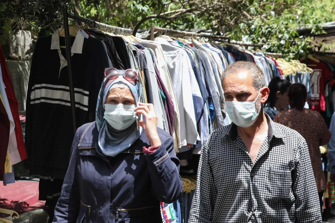 War-torn Syria has limited coronavirus testing capabilities and a heavily damaged health system. Above, residents shop for clothes at a flea market in Damascus on May 17, 2020. (AFP)