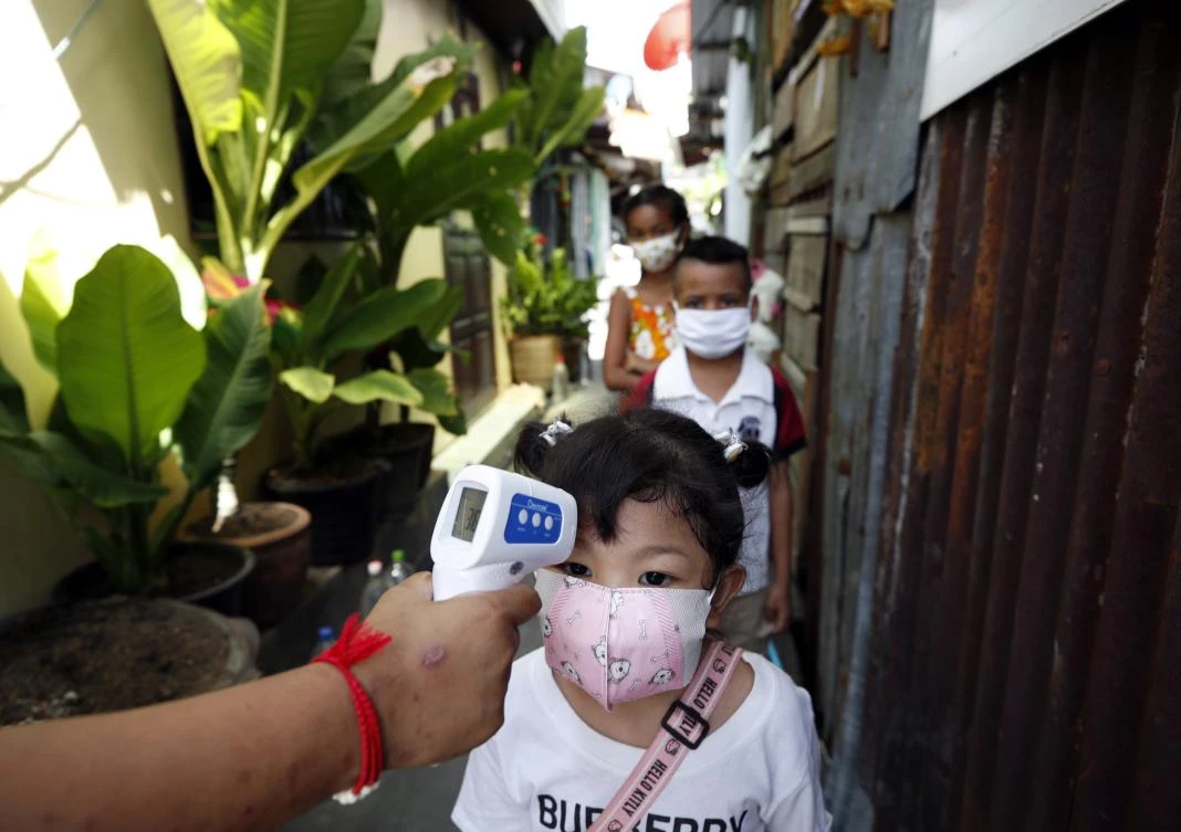 Above, children from low-income families have their temperature checked prior to attending a basic learning class in Bangkok, Thailand on May 21, 2020. (EPA)