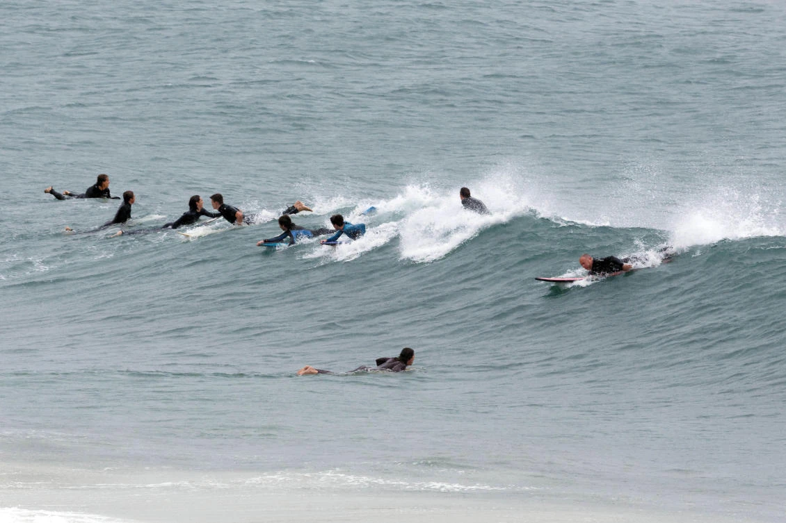 Surfers take to the water at Cottesloe beach in Perth to take advantage of unusually large waves created by tropical cyclone Mangga meeting a cold front off the west Australian coast on May 24, 2020. (AFP)