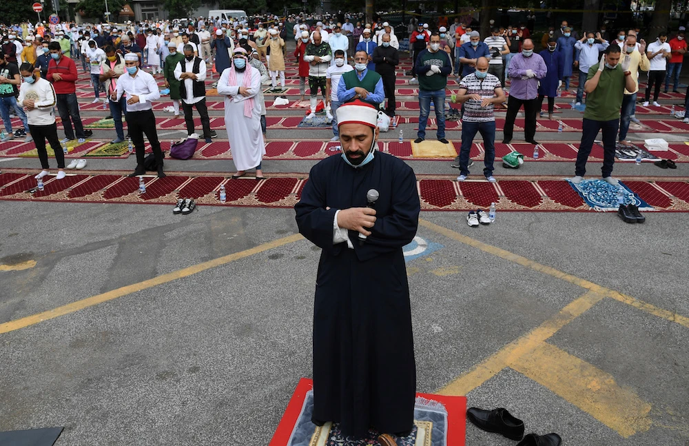 Muslim men pray on the first day of Eid Al-Fitr, as Italy eases some of the lockdown measures put in place during the coronavirus disease (COVID-19) outbreak, in Rome on Sunday. (Reuters)