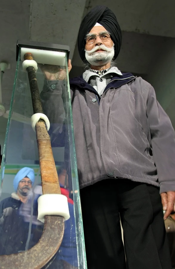 India’s three-time field hockey Olympic gold medallist Balbir Singh poses with the stick of Indian hockey legend Major Dhyan Chand Singh, with which Dhyan Chand played in the 1936 Berlin Olympics final, in Chandigarh. (File/AFP/Manan Vatsyayana)