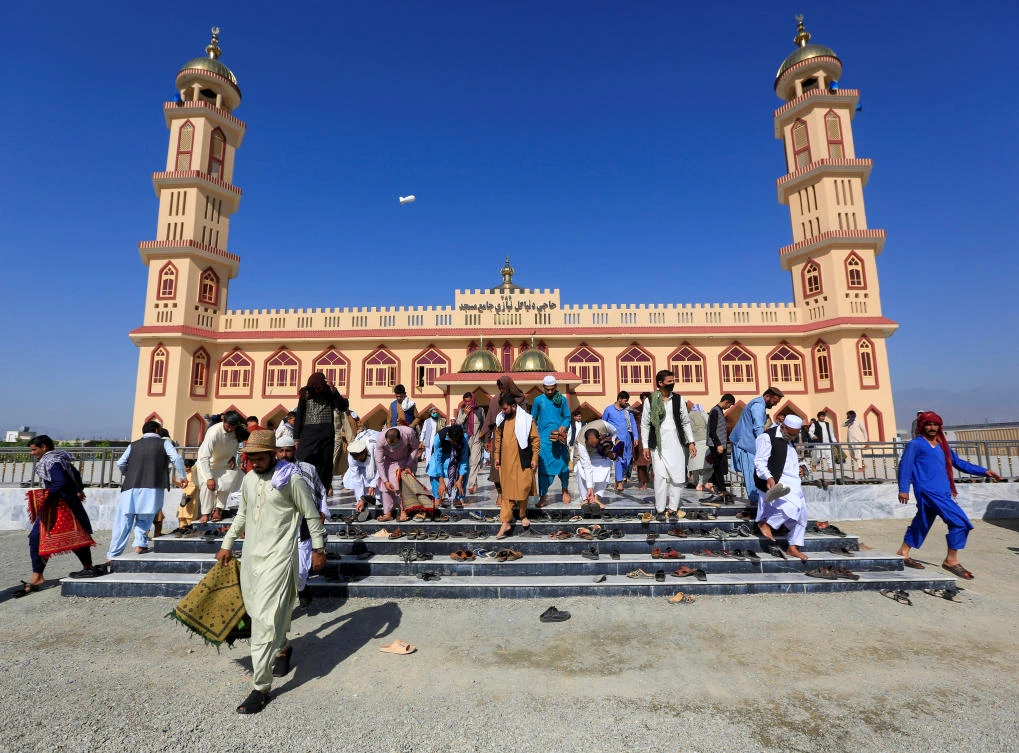 Afghan men leave a mosque after prayers during Eid al-Fitr, a Muslim festival marking the end the holy fasting month of Ramadan, amid the spread of the coronavirus disease (COVID-19), in Laghman province, Afghanistan May 24, 2020. (Reuters)