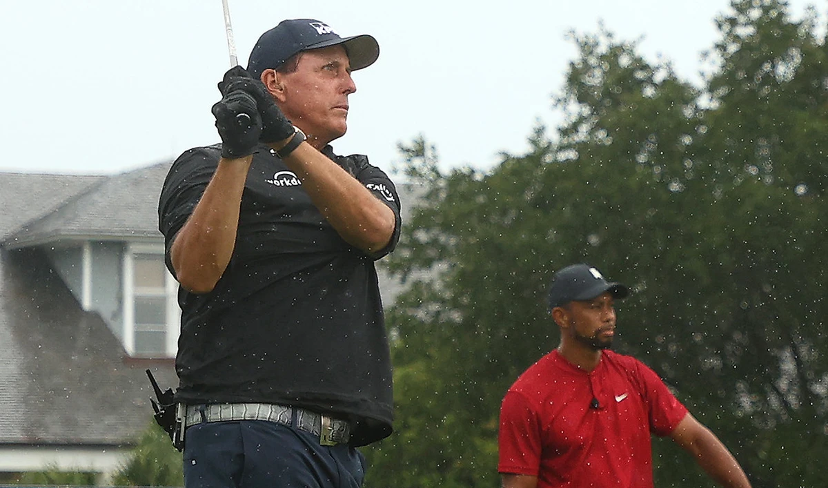 Phil Mickelson and Tiger Woods teamed with Tom Brady and Peyton Manning in a charity match that raised $20m. (Reuters)