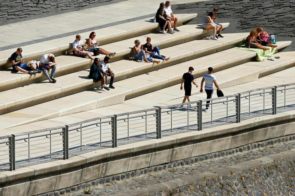 People enjoy the sun on the banks of the River Rhine, amid COVID-19 restrictions, in Cologne, Germany, May 21, 2020. (Reuters)