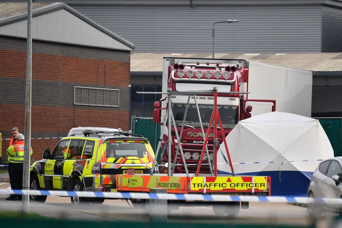 British Police officers stand on duty near to where a lorry, believed to have originated from Bulgaria, and containing 39 dead bodies, was discovered at Waterglade Industrial Park in Grays, east of London. (File/AFP)