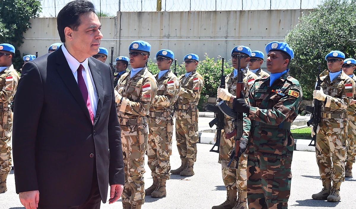 Lebanese Prime Minister Hassan Diab inspects the guard of honor at the UNIFIL headquarters in the southern coastal border town of Naqoura on Wednesday. (AP)
