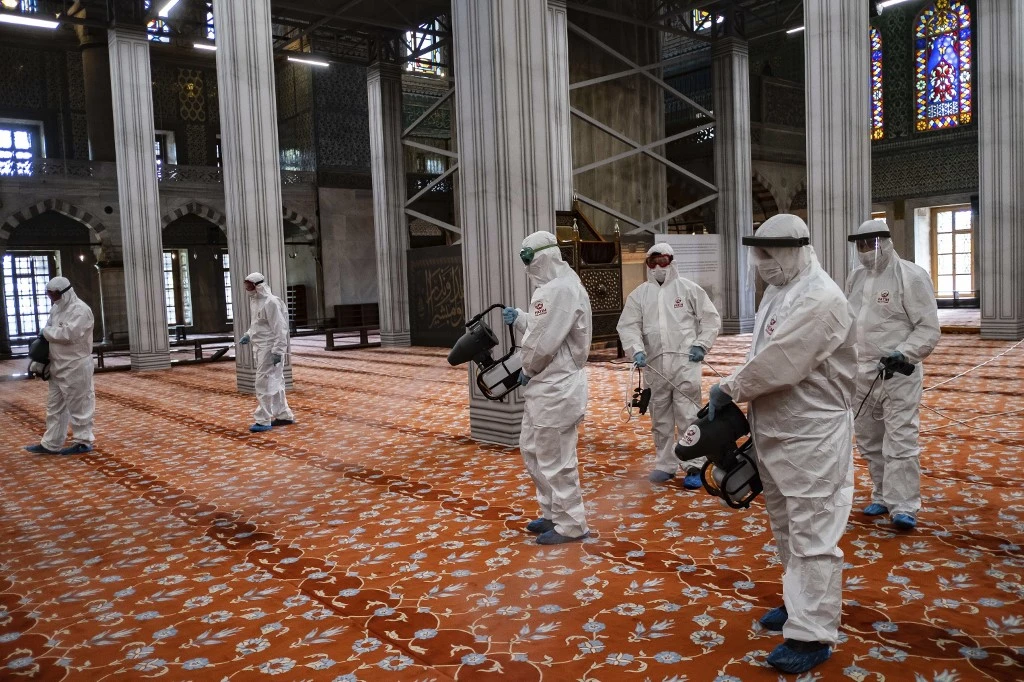 Fatih Municipality workers disinfect the Blue Mosque before its reopening. (AFP)