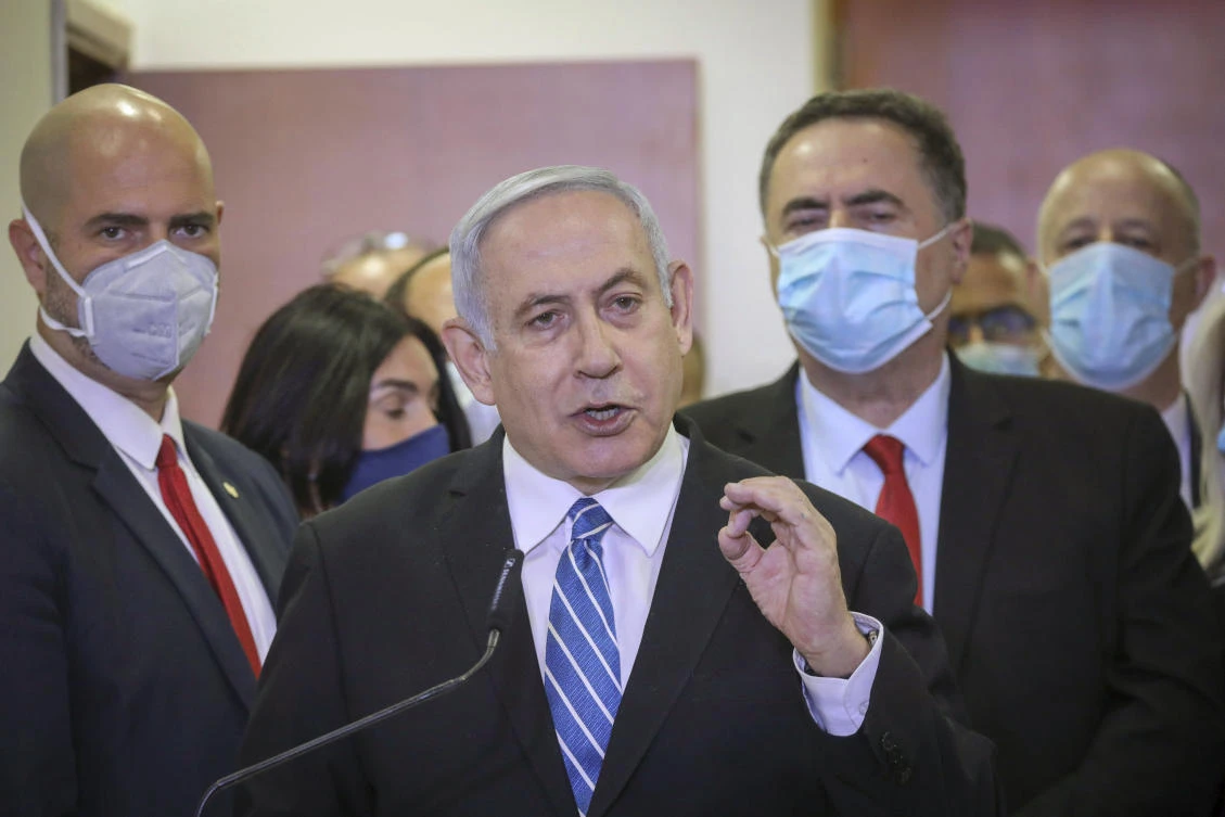 In this Sunday, May 24, 2020 photo, Israeli Prime Minister Benjamin Netanyahu accompanied by members of his Likud Party in masks delivers a statement before entering the district court in Jerusalem. (AP)