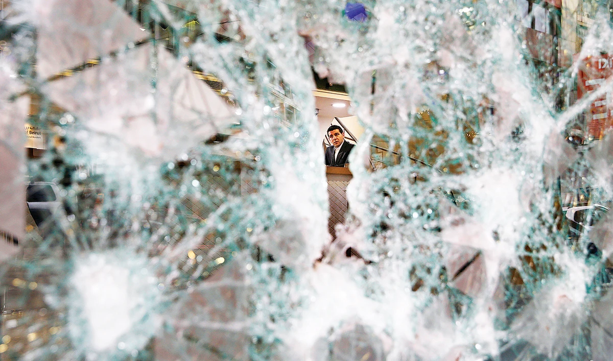 The windows of Bank of Beirut branches in the city have been smashed by angry crowds who have called the bank’s governor a thief. (AP)