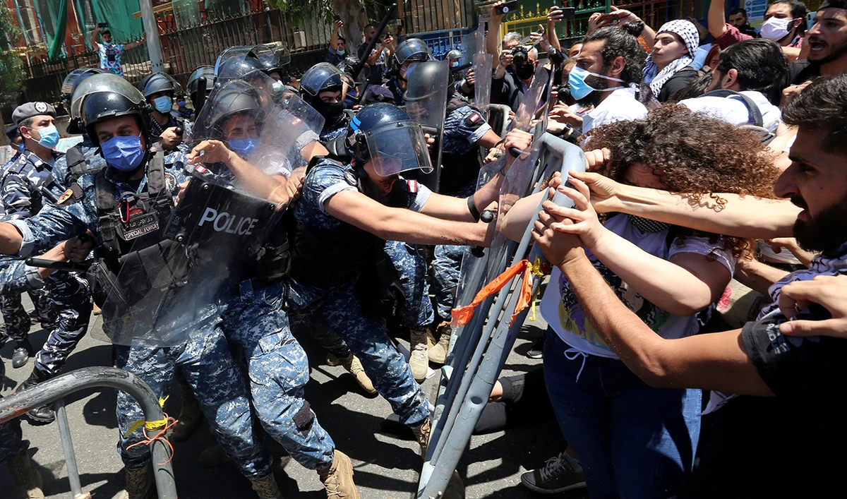 Demonstrators confront with riot police as they try to cross barricades on a road leading to the UNESCO Palace where Lebanon's parliament is holding a legislative session, during a protest against a controversial amnesty draft law, in Beirut Lebanon May 28, 2020. (Reuters)