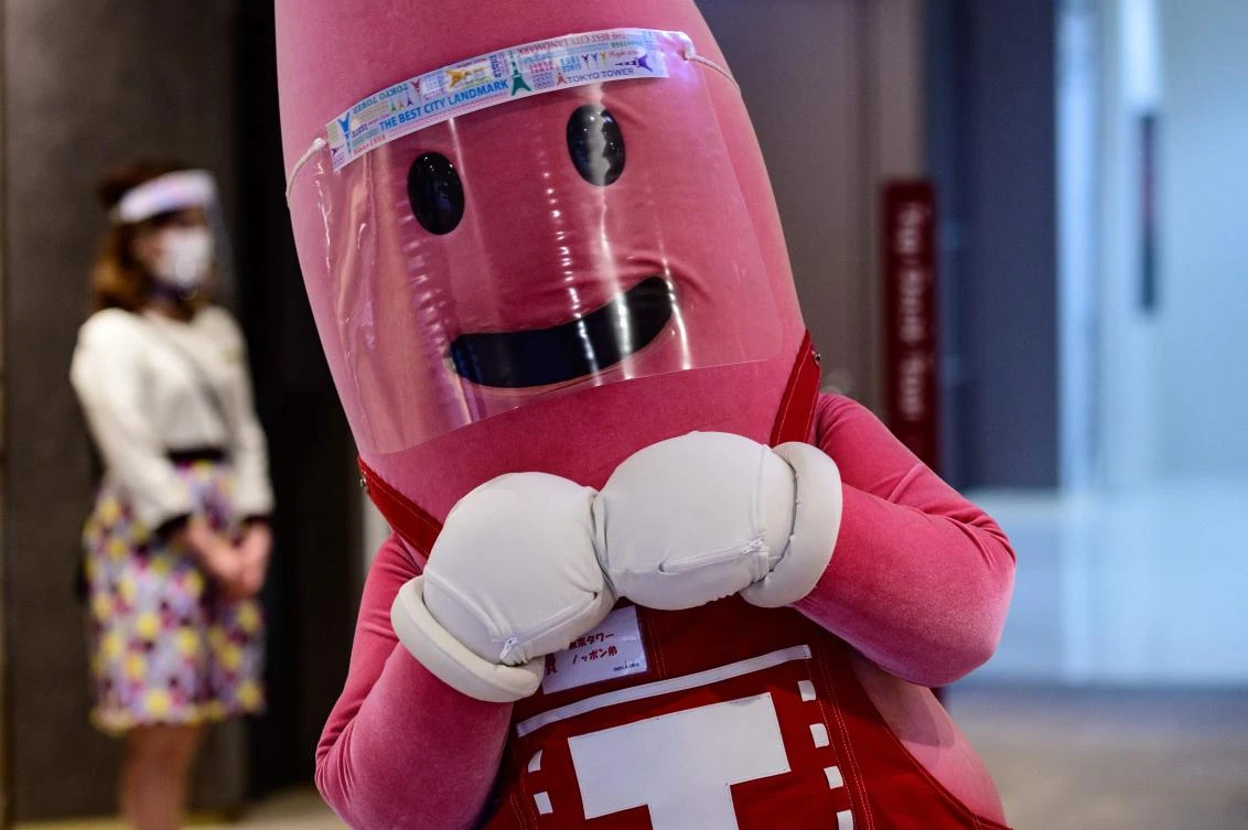 Japan lifted its state of emergency for Tokyo this week, following a drop in daily infections. Above, a mascot of Tokyo Tower waits to greet patrons on May 28, 2020. (AFP)
