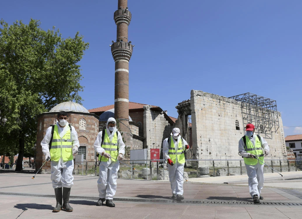 Above, municipality workers disinfect the courtyard of historical Haci Bayram Mosque in Ankara, Turkey on May 28, 2020. (AP)