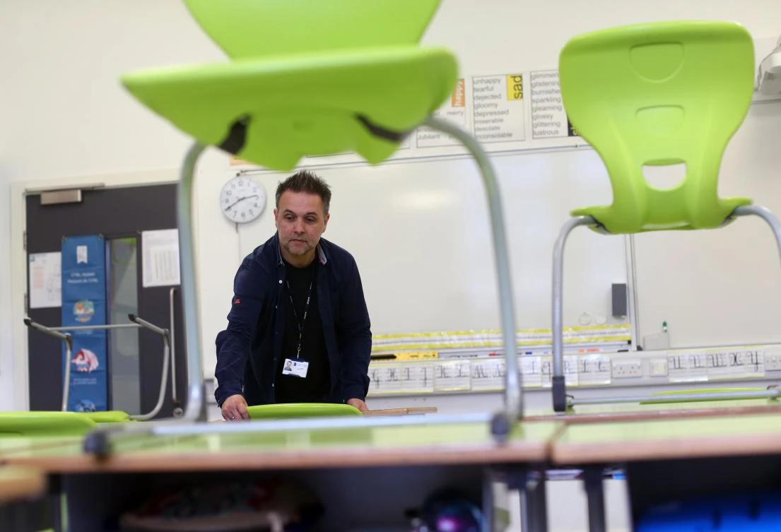 British primary schools are re-opening to certain year groups. Above, deputy head teacher David Gassian rearranges a classroom at Kentish Town, north London on May 27, 2020. (AFP)