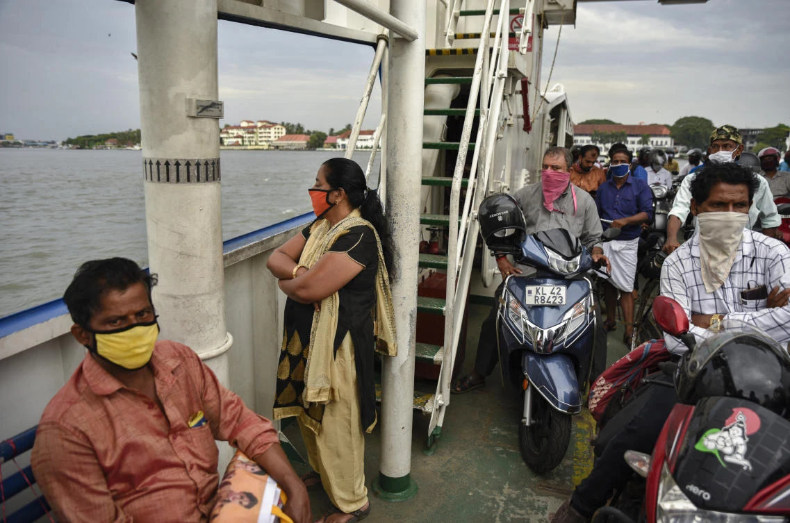 India’s total number of confirmed coronavirus cases is at 173,763 with 4,971 deaths. Above, residents wear masks travel in a ferry in Kochi, Kerala stat on May 29, 2020. (AP)