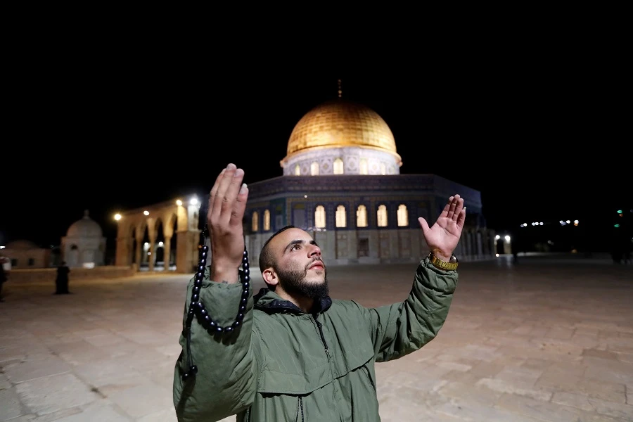 Plastinian Muslim worshippers pray at the al-Aqsa mosque compound, Islam's third holiest site, in Jerusalem's Old City on June 1, 2020, after a two-month closure due to the COVID-19 pandemic. (AFP)