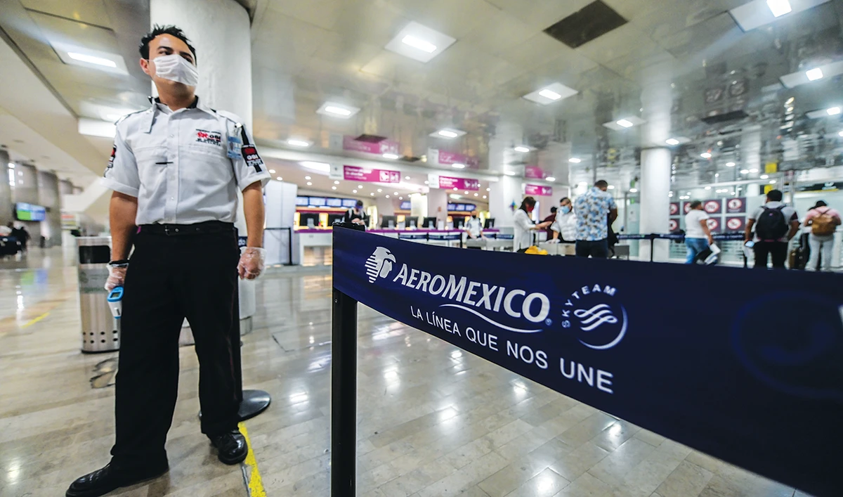 A security guard stands guard at the Benito Juarez International Airport, amid the outbreak of coronavirus disease in Mexico City. (Reuters/File)