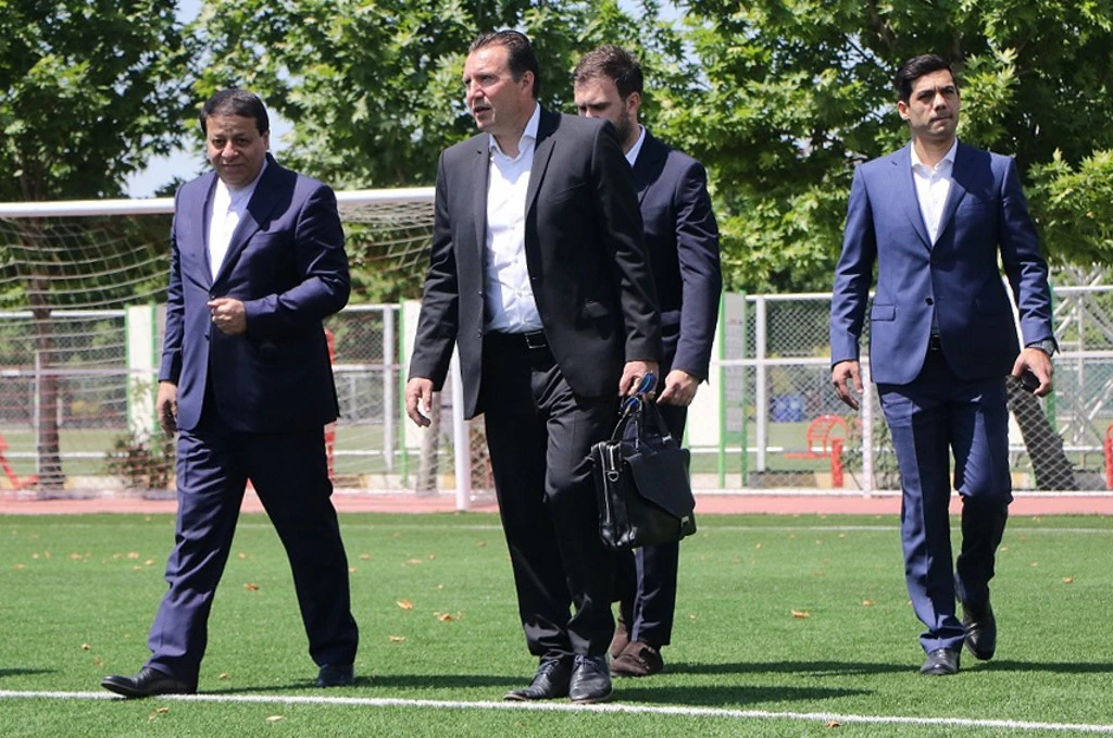 A handout picture provided by the Iranian Football Federation on May 15, 2019 shows the new coach of Iran's national football team, Marc Wilmots, (C). (File/AFP)