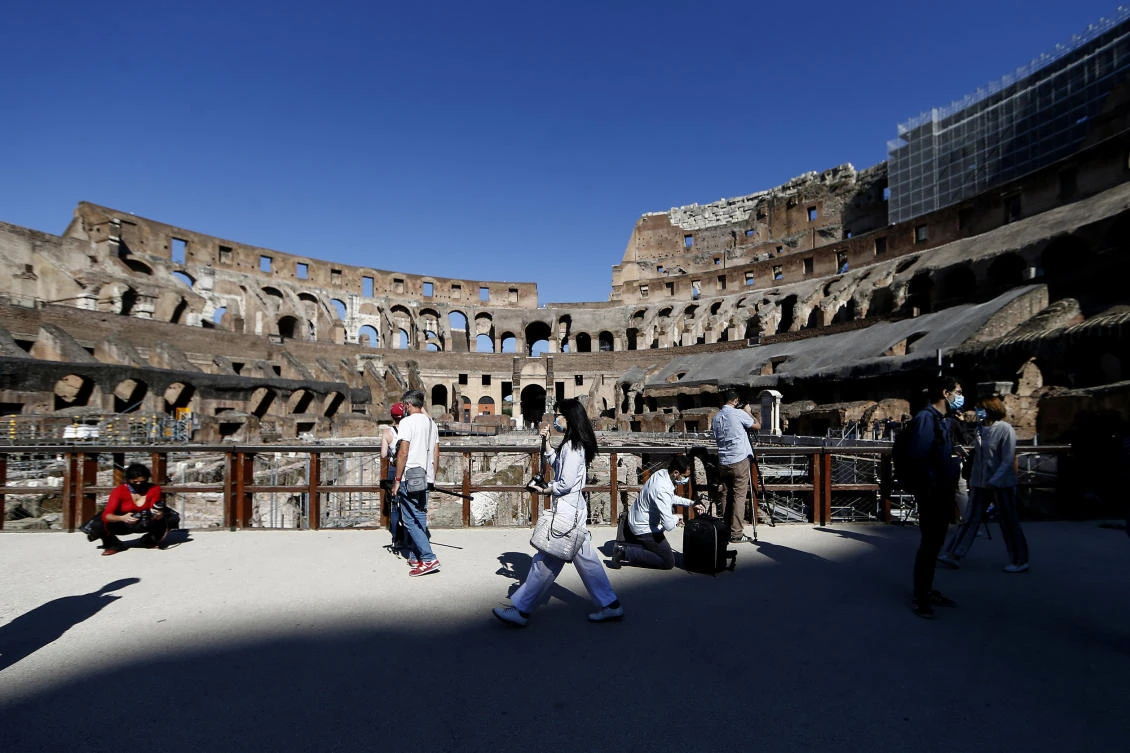 Members of the media walk inside the ancient Colosseum during a press preview for the reopening of the museum, in Rome, Monday, June 1, 2020. (AP)