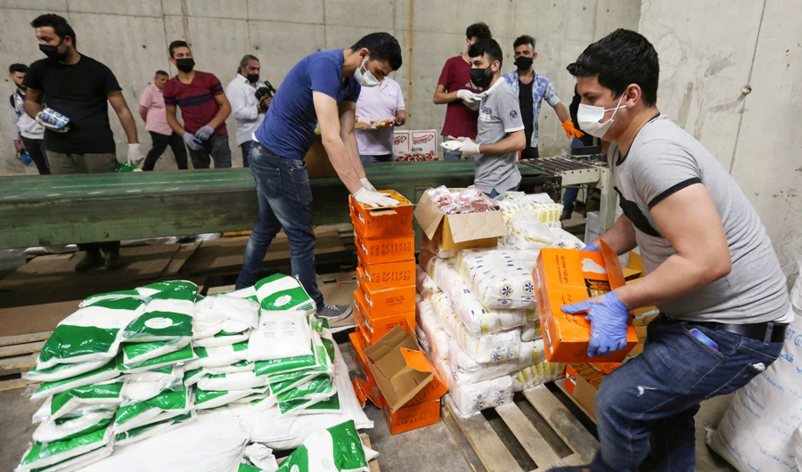 Volunteers sort boxes with food for distribution to people in need in Beirut, Lebanon amid safety measures to contain the coronavirus crisis. (Reuters)