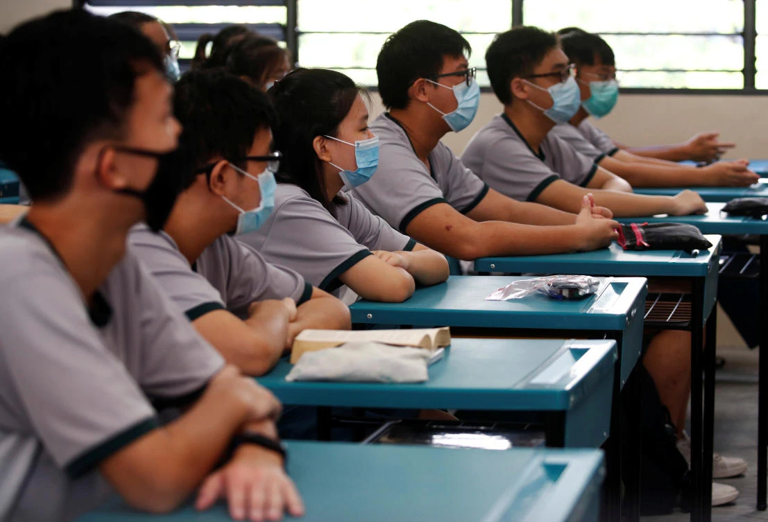 Students wearing protective face masks attend a class at Yio Chu Kang Secondary School, as schools reopen amid the coronavirus disease (COVID-19) outbreak in Singapore June 2, 2020. (Reuters)