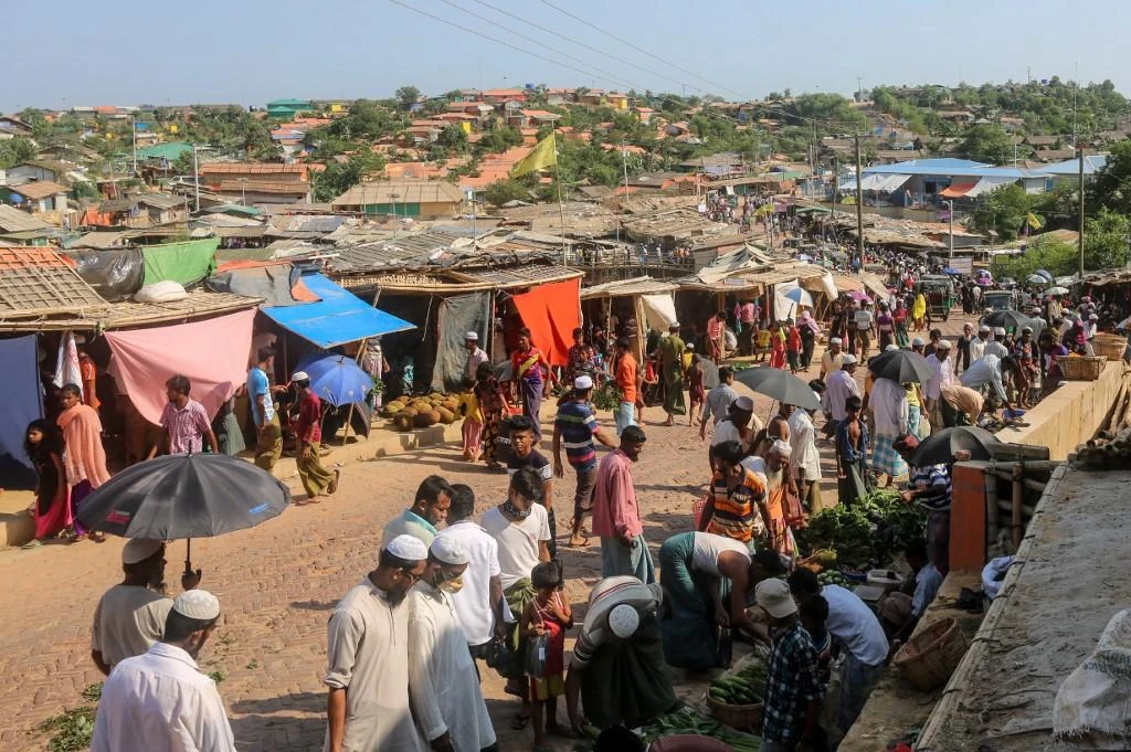 Rohingya refugees gather at a market as first cases of COVID-19 coronavirus have emerged in the area. (File/AFP)