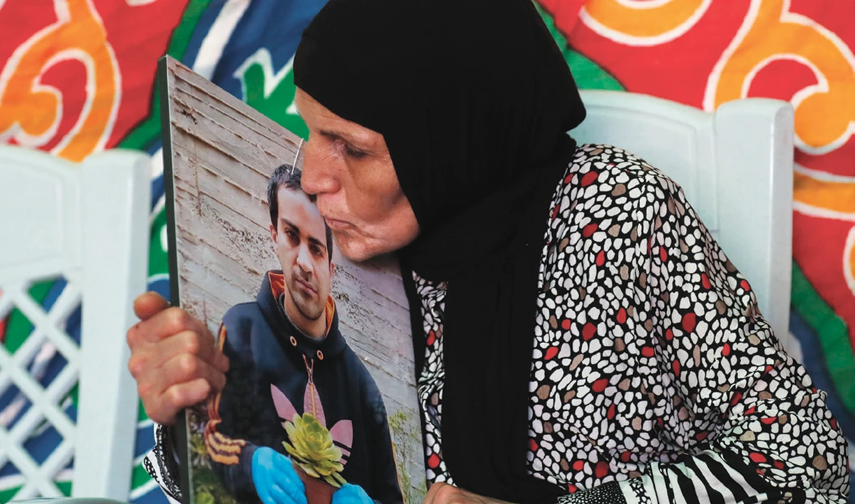 The mother of Iyad Hallak mourns her son at their home in East Jerusalem. (AFP)