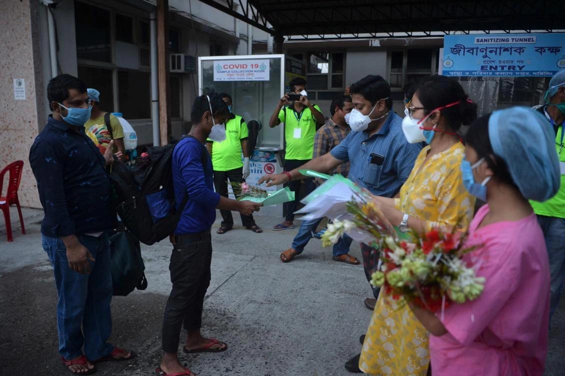 India’s infections are rising as it ends a severe lockdown of its 1.3 billion people imposed in March. Above, recovered COVID-19 patients collect certificates from hospital staff as they leave a hospital in Siliguri on June 2, 2020. (AFP)