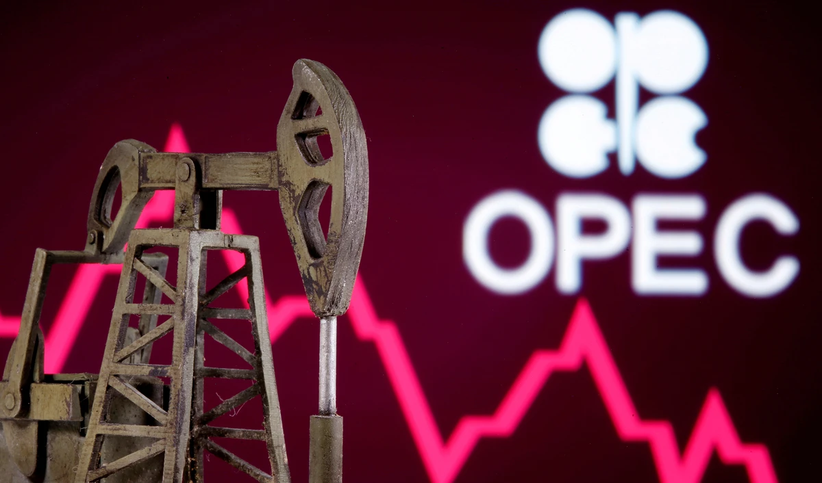 A 3D printed oil pump jack is seen in front of displayed stock graph and OPEC logo in this illustration picture captured on April 14, 2020. (REUTERS)