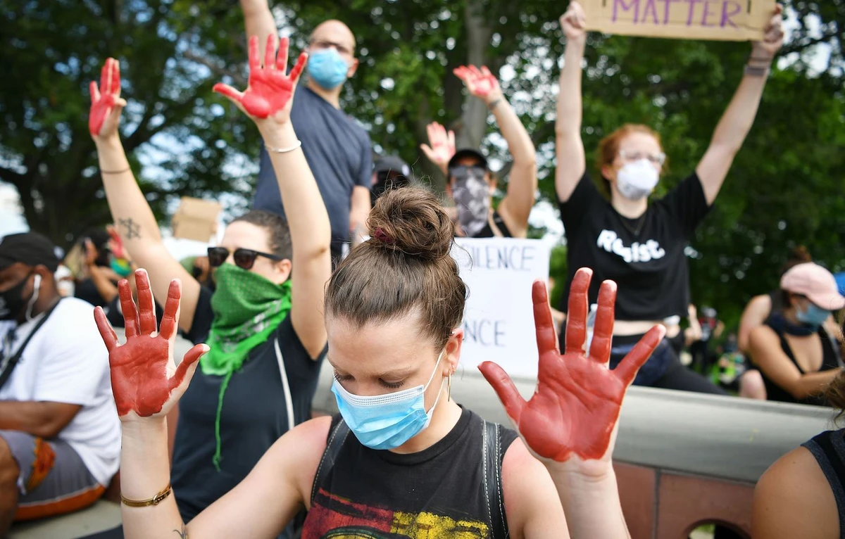 Demonstrators hold up their hands covered with red paint as they protest the death of George Floyd on the East Lawn of the US Capitol on June 3, 2020, in Washington, DC. (AFP)