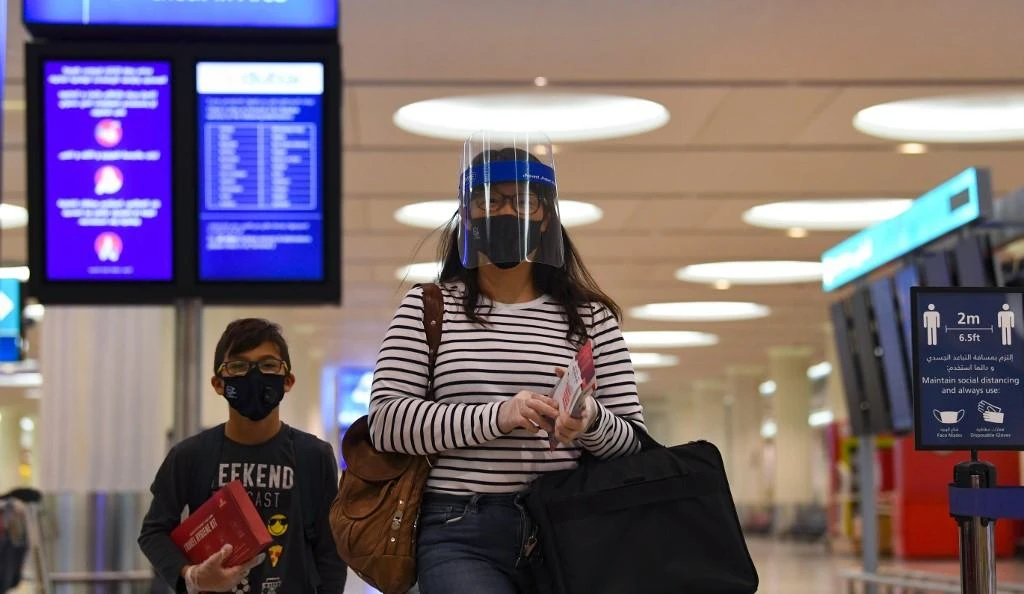 Passengers check in for departure at Dubai international airport. (File/AFP)