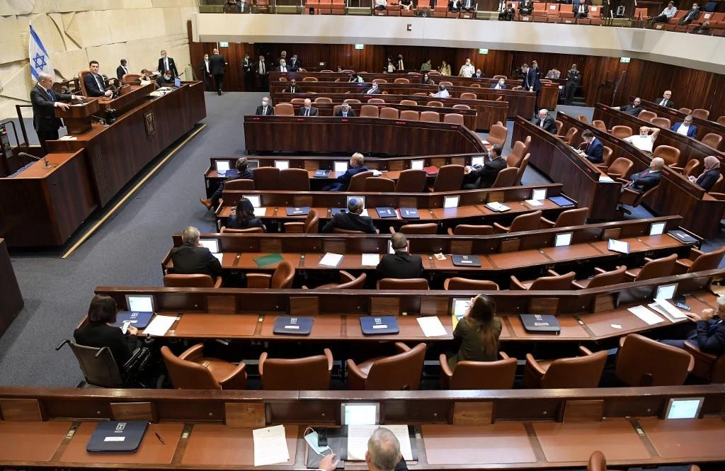 Prime Minister Benjamin Netanyahu, left, speaks before the Israeli parliament during a swearing-in ceremony of the new government in Jerusalem on May 17, 2020. (Knesset Spokesperson Office via AFP)