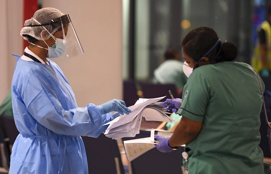 A member of an Indian medical team registers upon her arrival at Dubai International Airport on May 9, 2020, to help with the coronavirus (COVID-19) pandemic. (File/AFP)