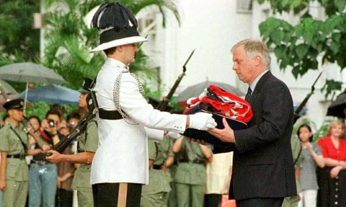 Chris Patten receives the union flag after it was lowered for the last time in Hong Kong, June 30, 1997. (Shutterstock)