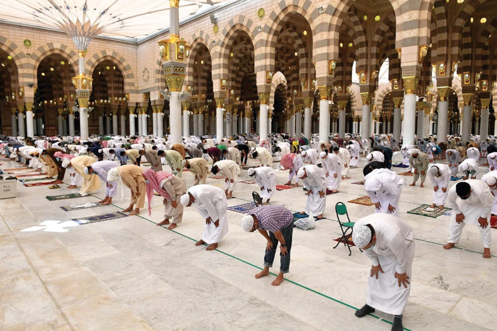 Worshippers observe the "social distancing" rule while praying inside the Prophet's Mosque on Friday. (SPA)