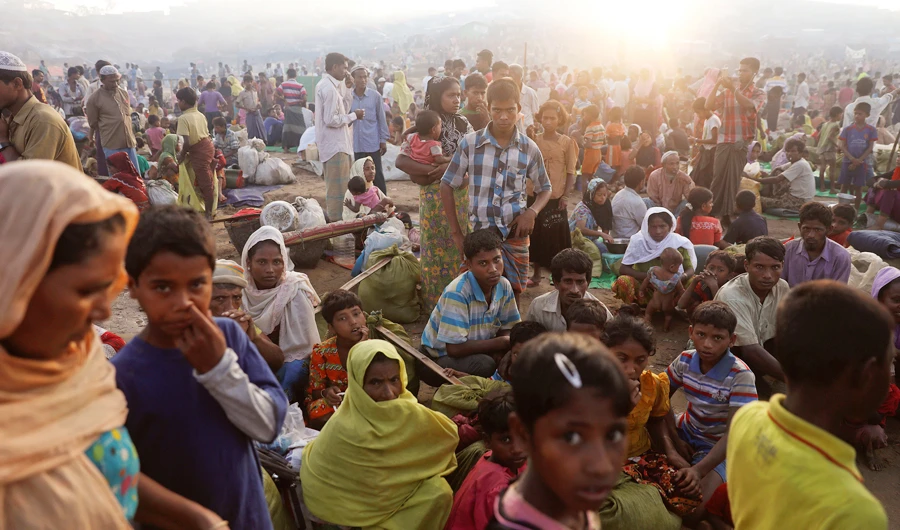The sun rises as thousands of Rohingya refugees who fled from Myanmar a day before wait by the road where they spent the night between refugee camps, near Cox's Bazar, Bangladesh October 10, 2017. (REUTERS)