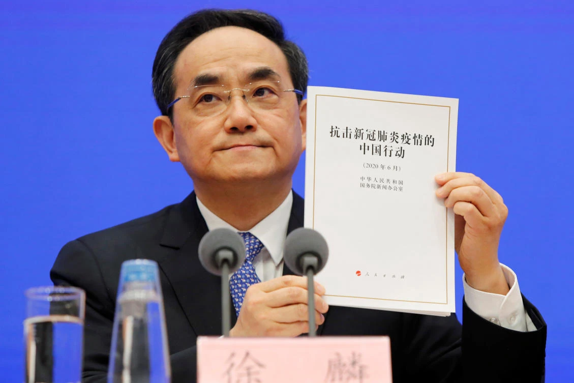 Xu Lin, vice head of the publicity department of the Communist Party of China (CPC) Central Committee, holds a copy of the white paper about China's fight against the coronavirus disease (COVID-19) during a State Council Information Office (SCIO) briefing in Beijing, China June 7, 2020. (Reuters)