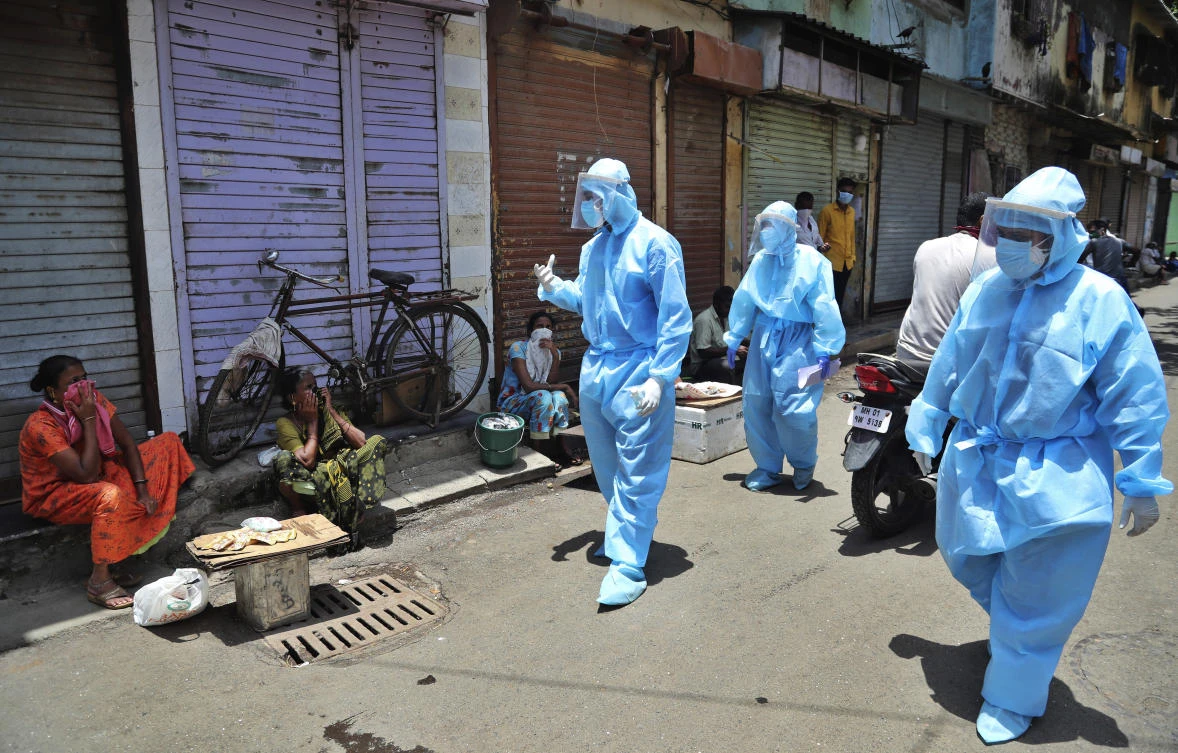 Doctors request roadside vendors to wear masks during a free medical camp in Dharavi, one of Asia's largest slums in Mumbai, India, Sunday, June 7, 2020. (AP)