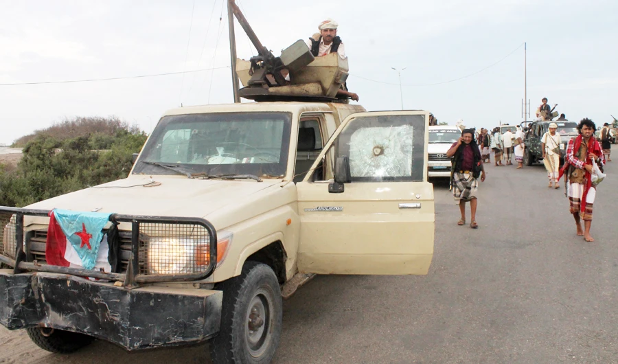 Yemeni armed members of a local armed resistance group, known as a Popular Committee (PC), supporting President Abedrabbo Mansour Hadi, arrive on March 23, 2015 from the city of Abyan in Aden. (AFP)
