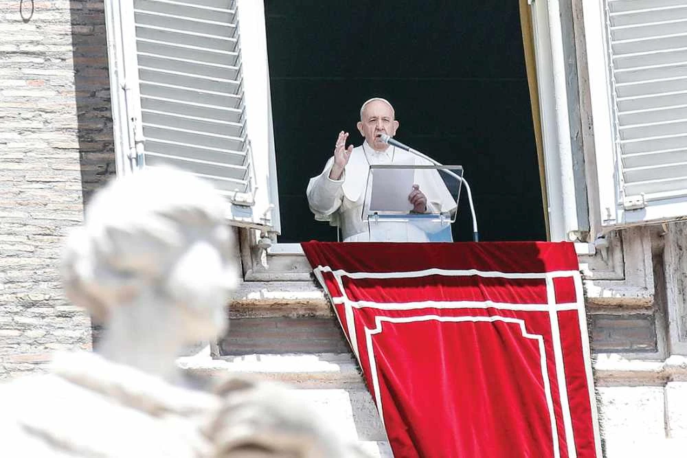 Pope Francis, addressing Catholics in St. Peter’s Square for the first time since the pandemic began, waves during the Sunday Angelus prayer at the Vatican. (AFP)