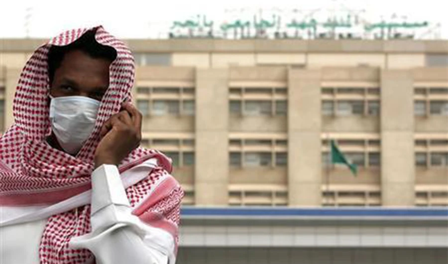 A man, wearing a surgical mask as a precautionary measure against the novel coronavirus, walks near a hospital in Khobar city in Dammam May 21, 2013. (REUTERS)