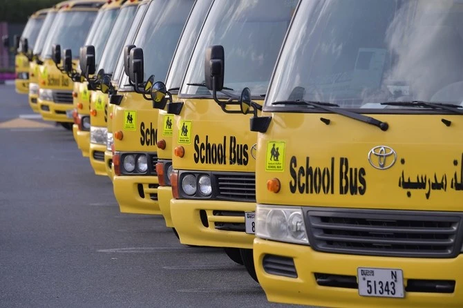 A picture taken on March 15, 2020 shows school buses parked outside a closed school in Dubai. (File/AFP)
