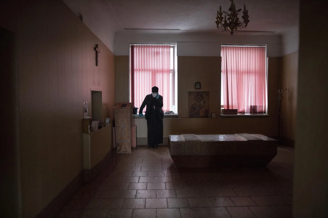 In this photo taken on Monday, June 1, 2020, Father Vasily Gelevan takes a rest after conducting a funeral service at a hospital morgue in Moscow, Russia. (AP)