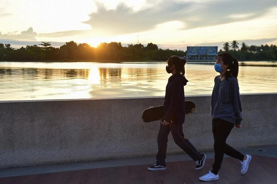 Women wearing face masks walk in a park in Thailand's southern province of Narathiwat on June 5, 2020, as restrictions aimed at curbing the spread of the COVID-19 novel coronavirus are slowly eased in Thailand. (File/AFP)