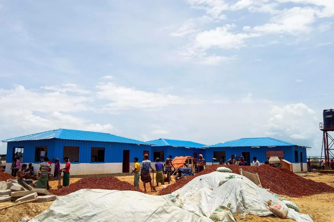 Rohingya refugees work to build a quarantine centre at the Kutupalong refugee camp in Ukhia on June 4, 2020. Rohingya refugees are so fearful of failing coronavirus tests that they have fled isolation centres in camps in Bangladesh where the first death of one of the Muslim outcasts has heightened nerves over the spread of the pandemic, according to community leaders. (AFP)