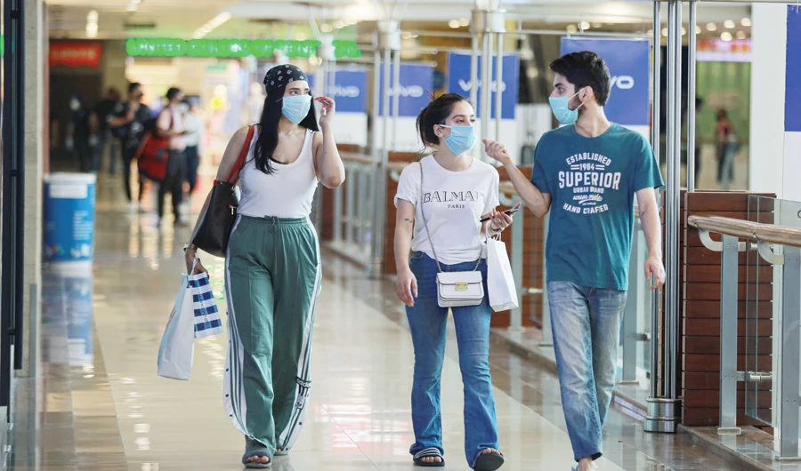 People wearing masks enjoy shopping on Monday inside a mall in New Delhi as India eases lockdown restrictions that were imposed to slow the spreadof virus. (Reuters)